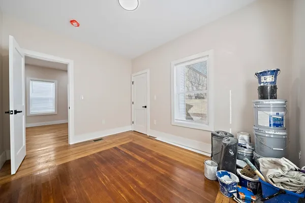 wooden floor in an empty room with a window