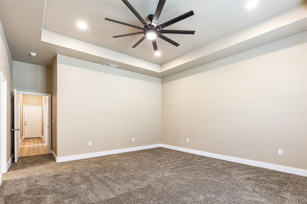 413 Henderson Street Bonham, TX 75418 - Photo 17 of 27 en empty room with windows and fan