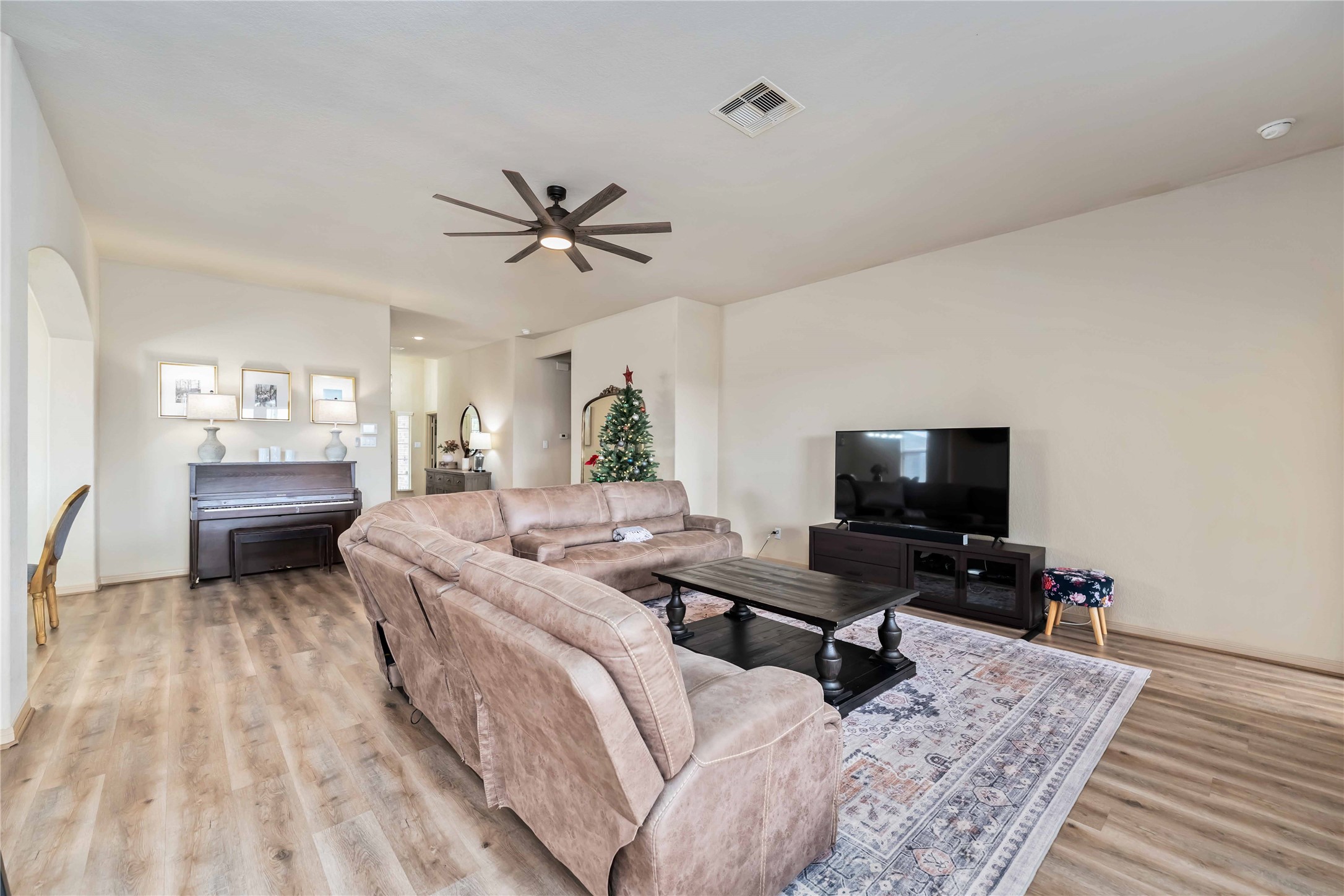 2502 Tiger Eye Drive Rosharon, TX 77583 - Photo 18 of 29 This spacious living room flows into a dining area, creating an open-concept feel.