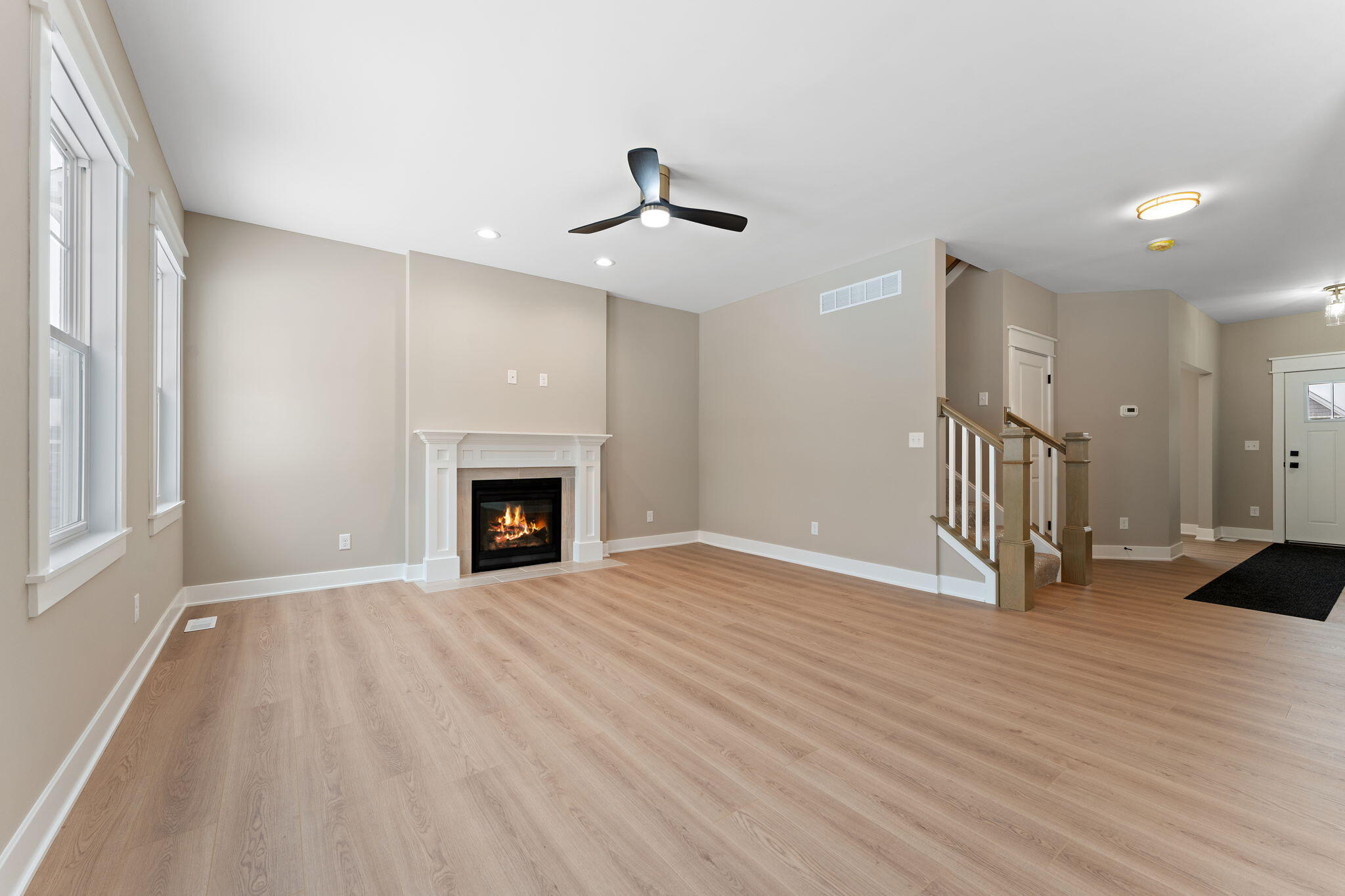 2132 Pradera Trail Chesterton, IN 46304 - Photo 12 of 45 a view of an empty room with wooden floor fireplace and a window