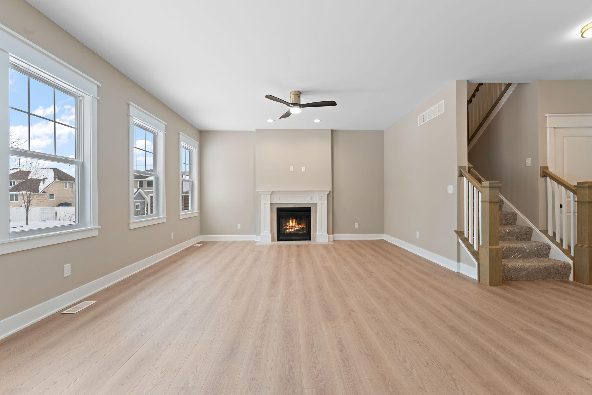 2132 Pradera Trail Chesterton, IN 46304 - Photo 12 of 46 an empty room with wooden floor fireplace and windows