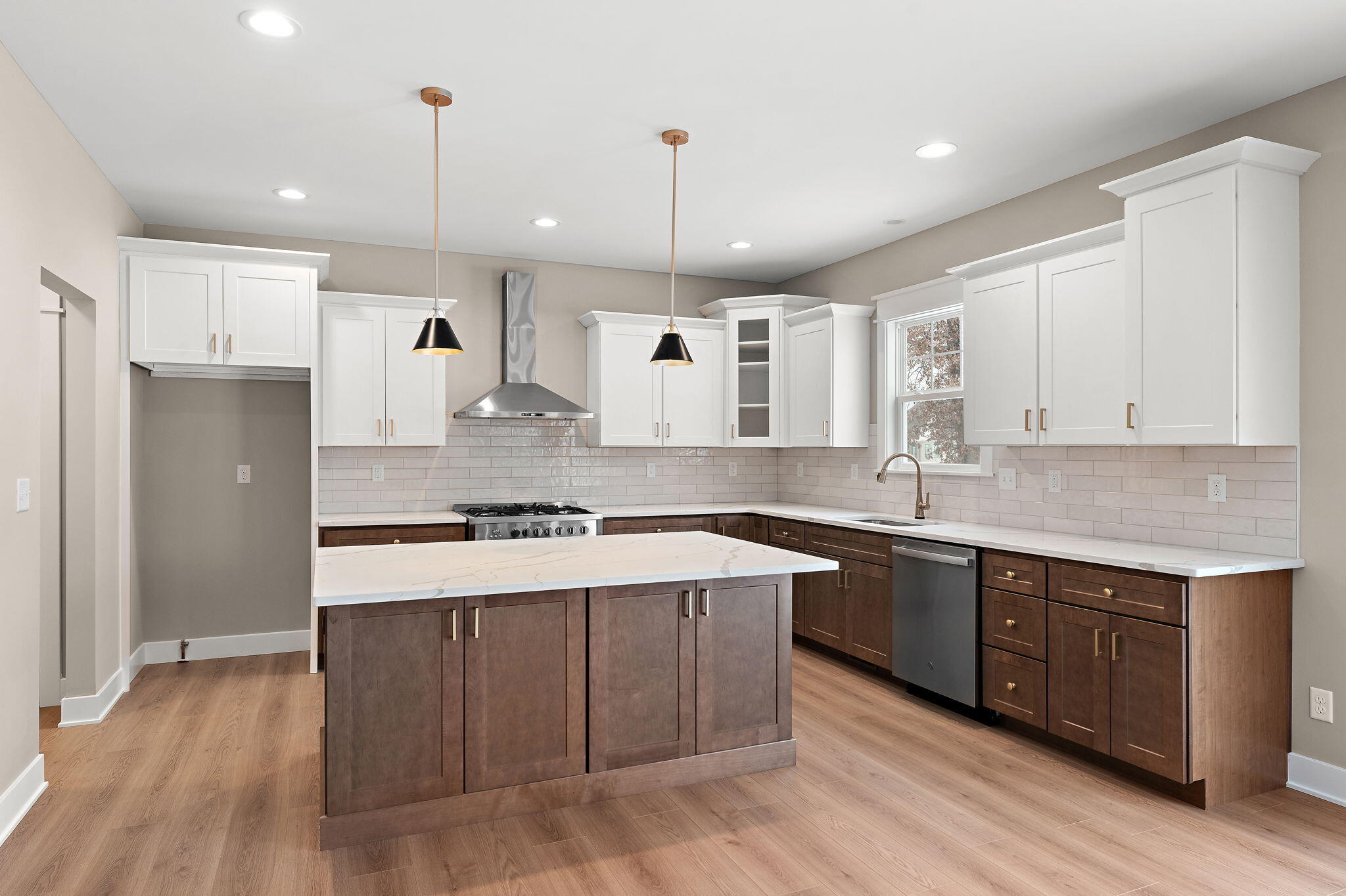 2132 Pradera Trail Chesterton, IN 46304 - Photo 17 of 46 a large kitchen with stainless steel appliances kitchen island granite countertop a stove a sink a refrigerator and white cabinets with wooden floor
