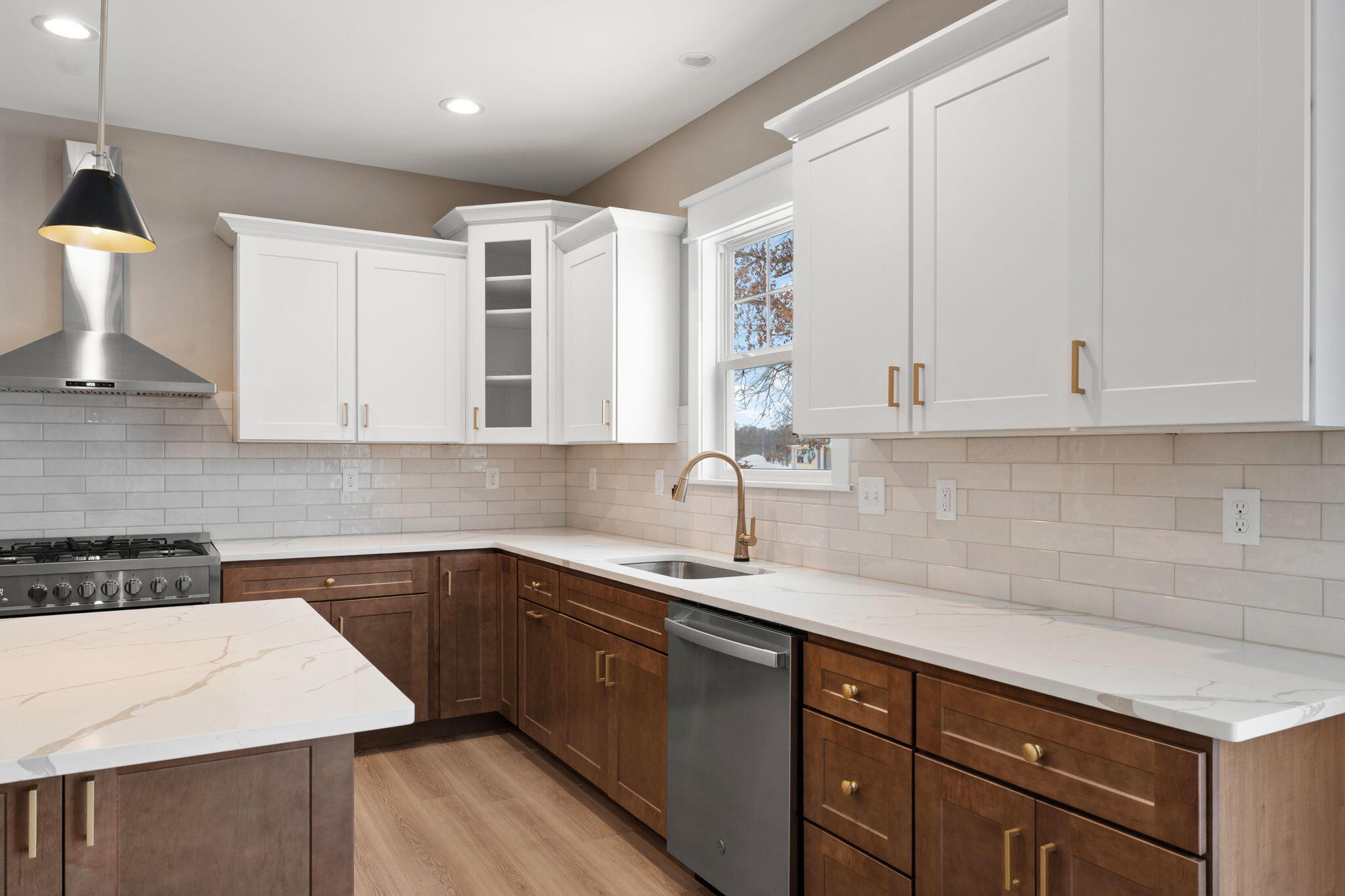 2132 Pradera Trail Chesterton, IN 46304 - Photo 22 of 46 a kitchen with a sink dishwasher and white cabinets with wooden floor