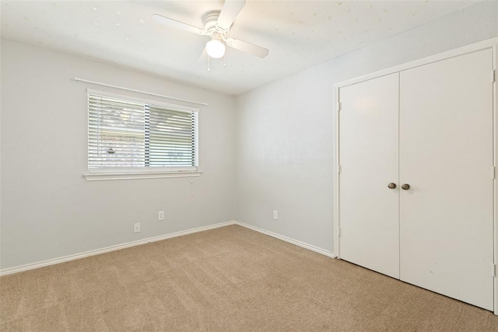 3010 Rambling Drive Dallas, TX 75228 - Photo 17 of 25 Carpeted room with a ceiling fan, a window featuring horizontal blinds, and a built-in closet with bi-fold doors