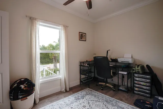 a view of a workspace with furniture and a window