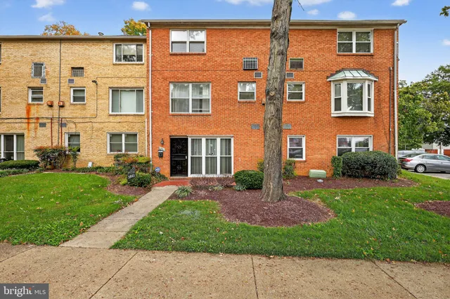 front view of a brick house with a yard