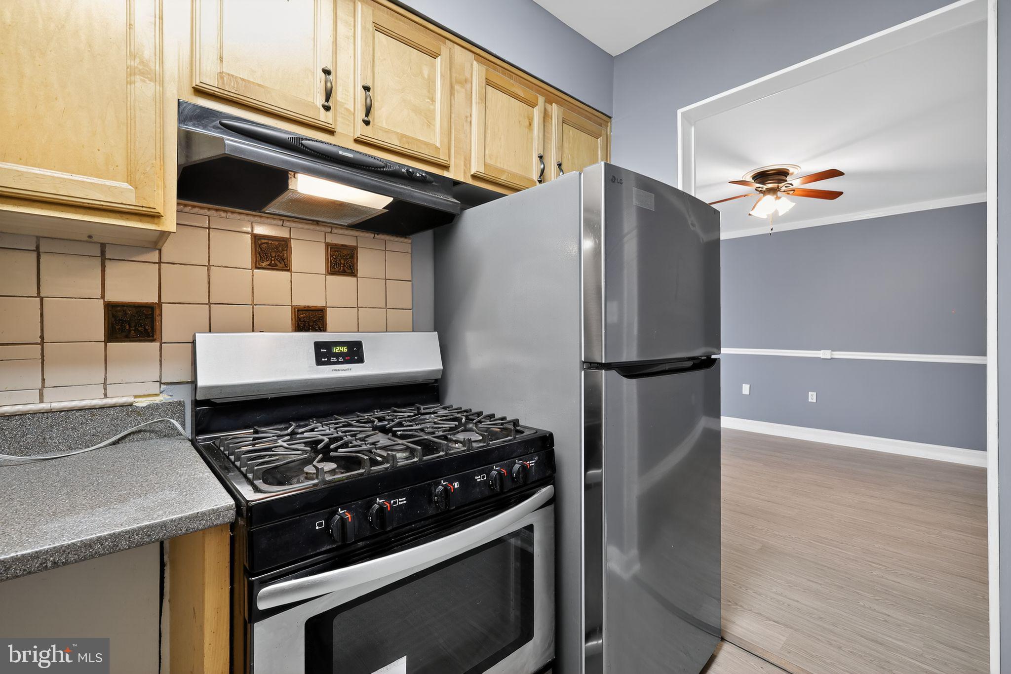 1621 Addison Road South District Heights, MD 20747 - Photo 11 of 15 a kitchen with stainless steel appliances granite countertop a stove and a refrigerator