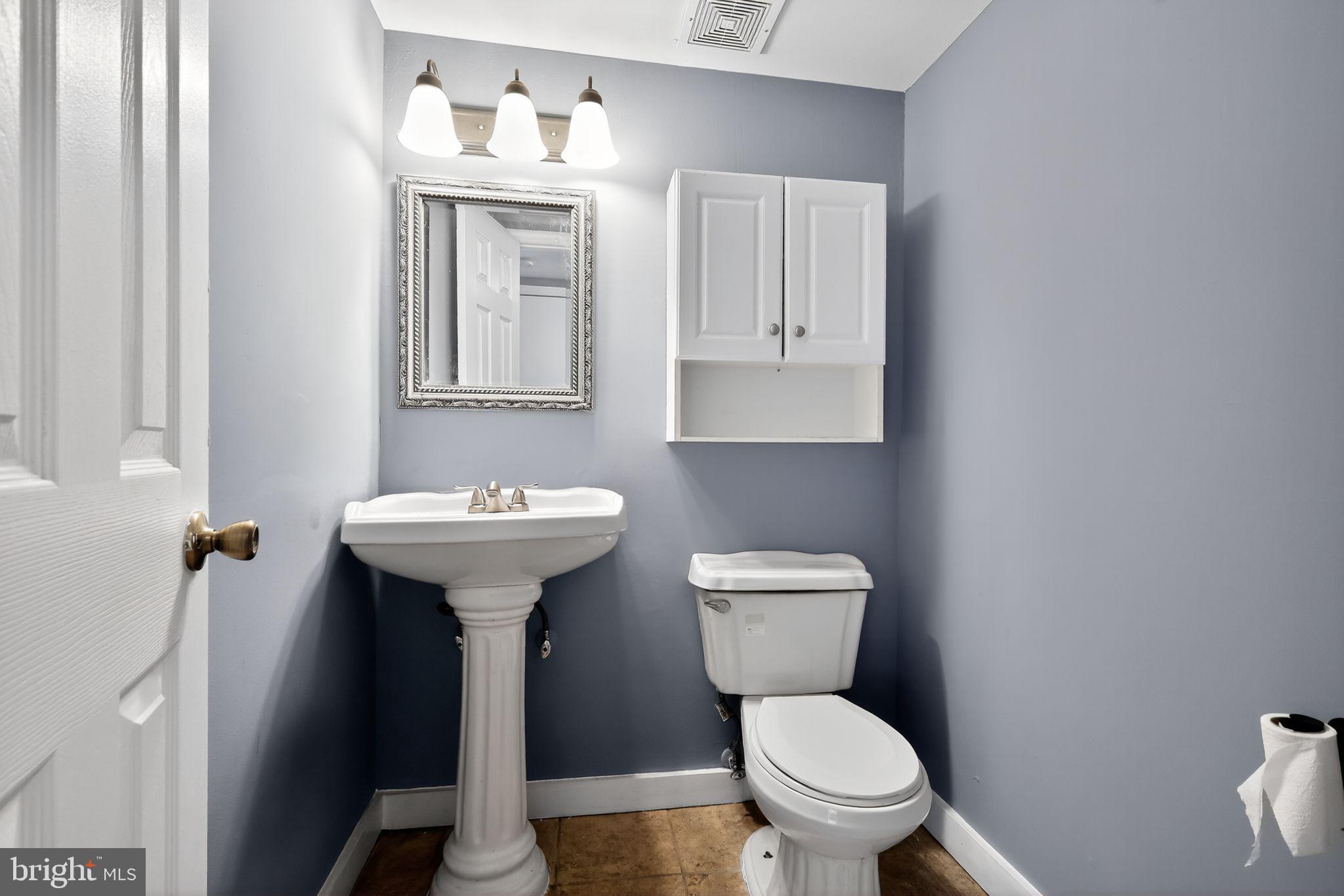 1621 Addison Road South District Heights, MD 20747 - Photo 13 of 15 a bathroom with a toilet sink and mirror