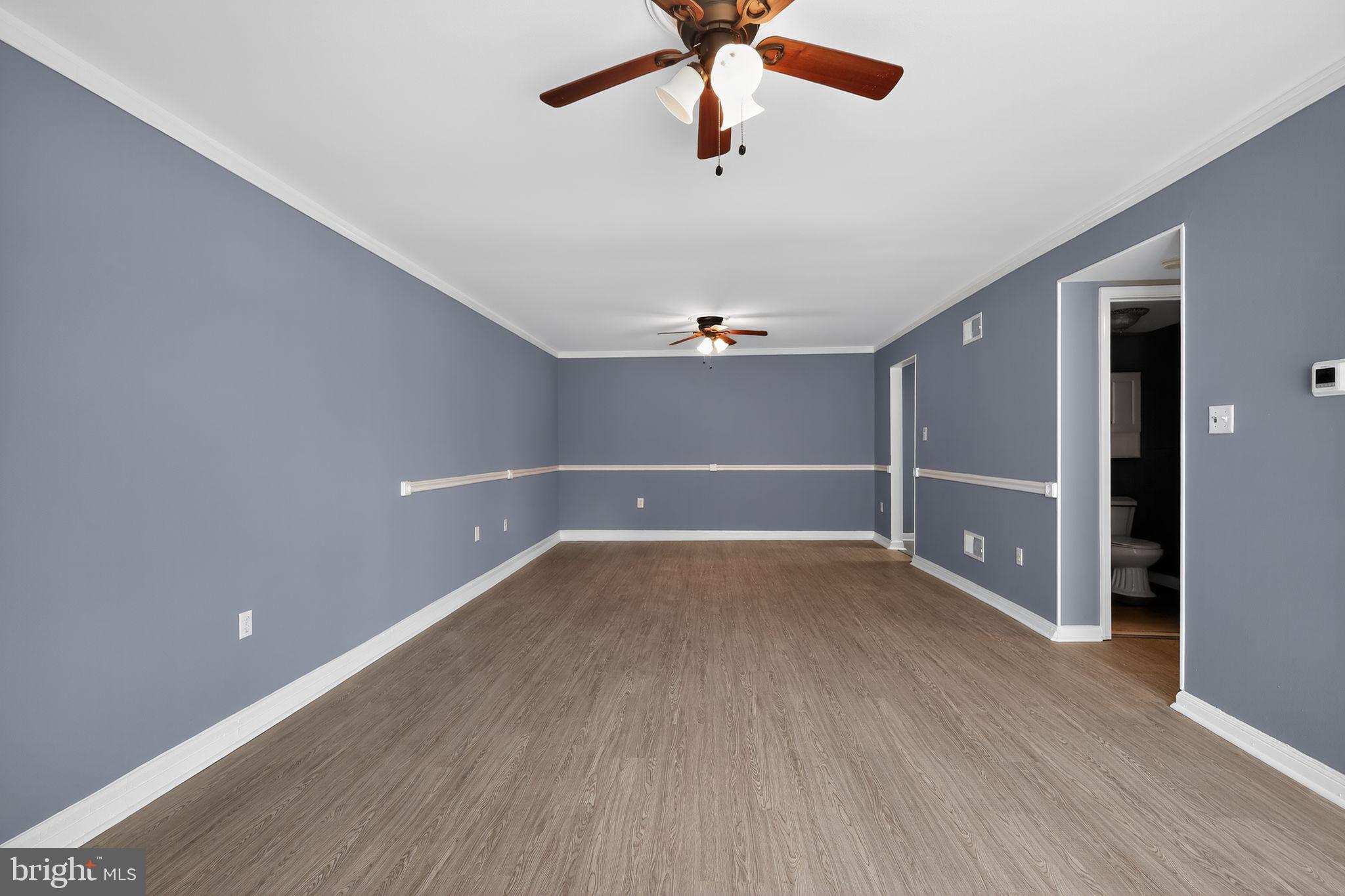 1621 Addison Road South District Heights, MD 20747 - Photo 4 of 15 an empty room with wooden floor closet and windows