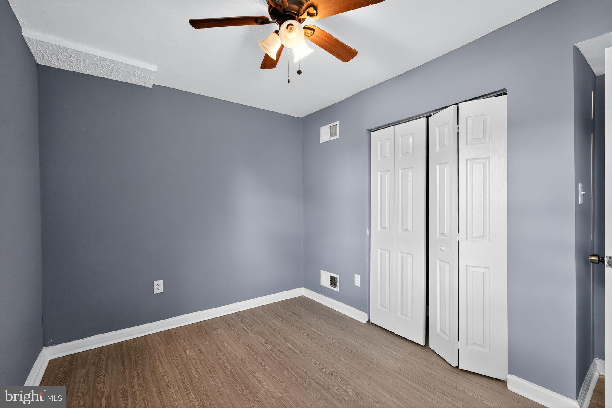 1621 Addison Road South District Heights, MD 20747 - Photo 6 of 15 an empty room with a ceiling fan and wooden floor