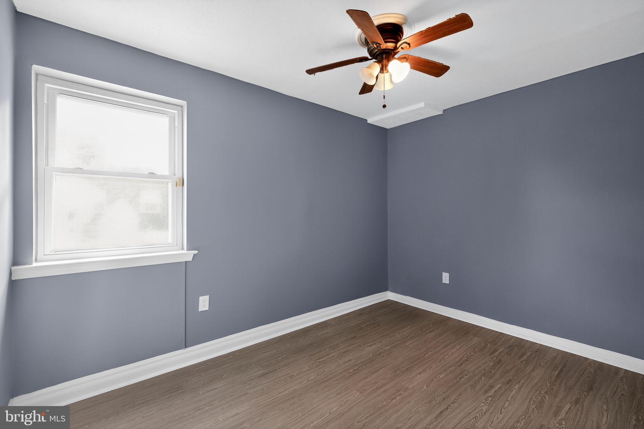 1621 Addison Road South District Heights, MD 20747 - Photo 9 of 15 an empty room with a window and a ceiling fan