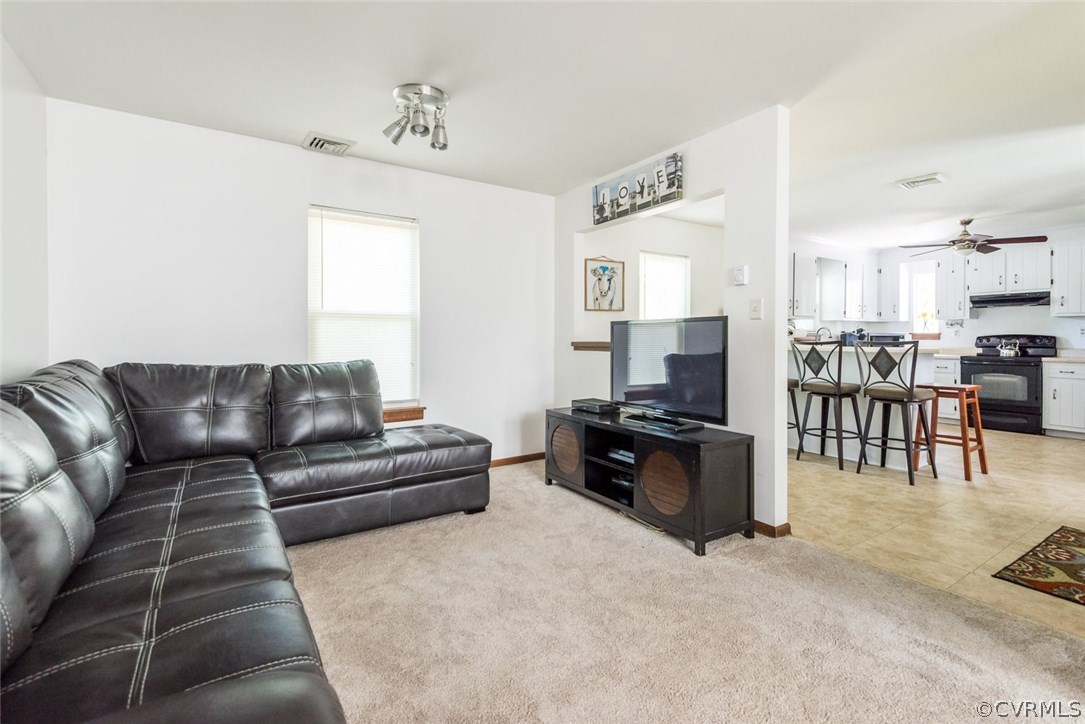 10331 Genlou Road Chesterfield, VA 23832 - Photo 8 of 25 a living room with furniture and a flat screen tv