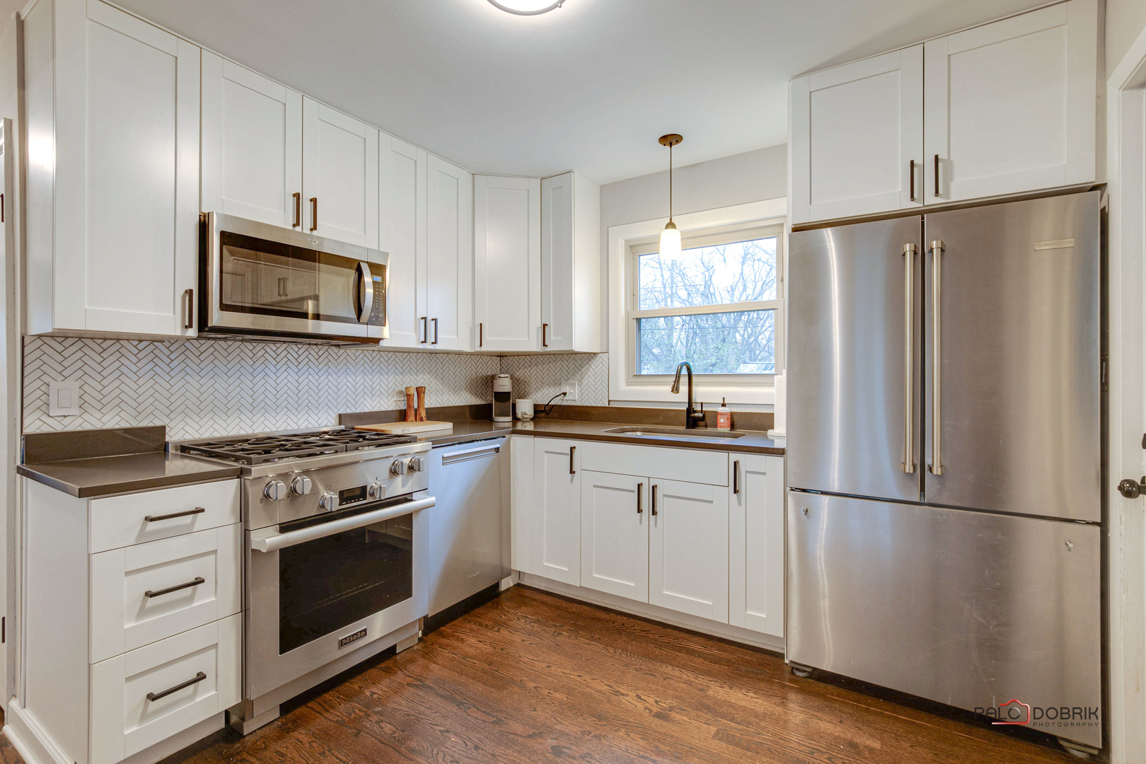 706 Deerpath Drive Deerfield, IL 60015 - Photo 11 of 36 a kitchen with cabinets stainless steel appliances and wooden floor