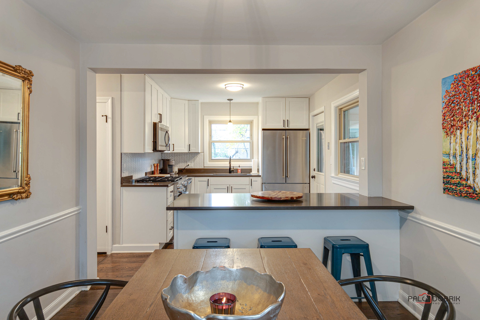 706 Deerpath Drive Deerfield, IL 60015 - Photo 7 of 36 a kitchen with stainless steel appliances granite countertop a sink a stove a refrigerator cabinets and dining table
