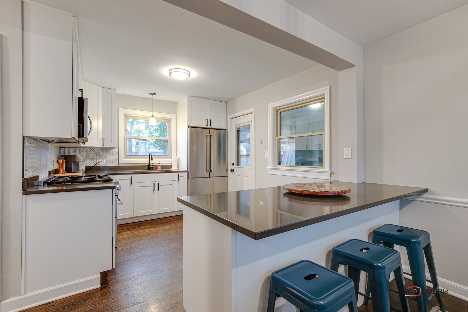 706 Deerpath Drive Deerfield, IL 60015 - Photo 9 of 36 a kitchen with stainless steel appliances granite countertop a sink dishwasher a stove and a refrigerator with wooden floor