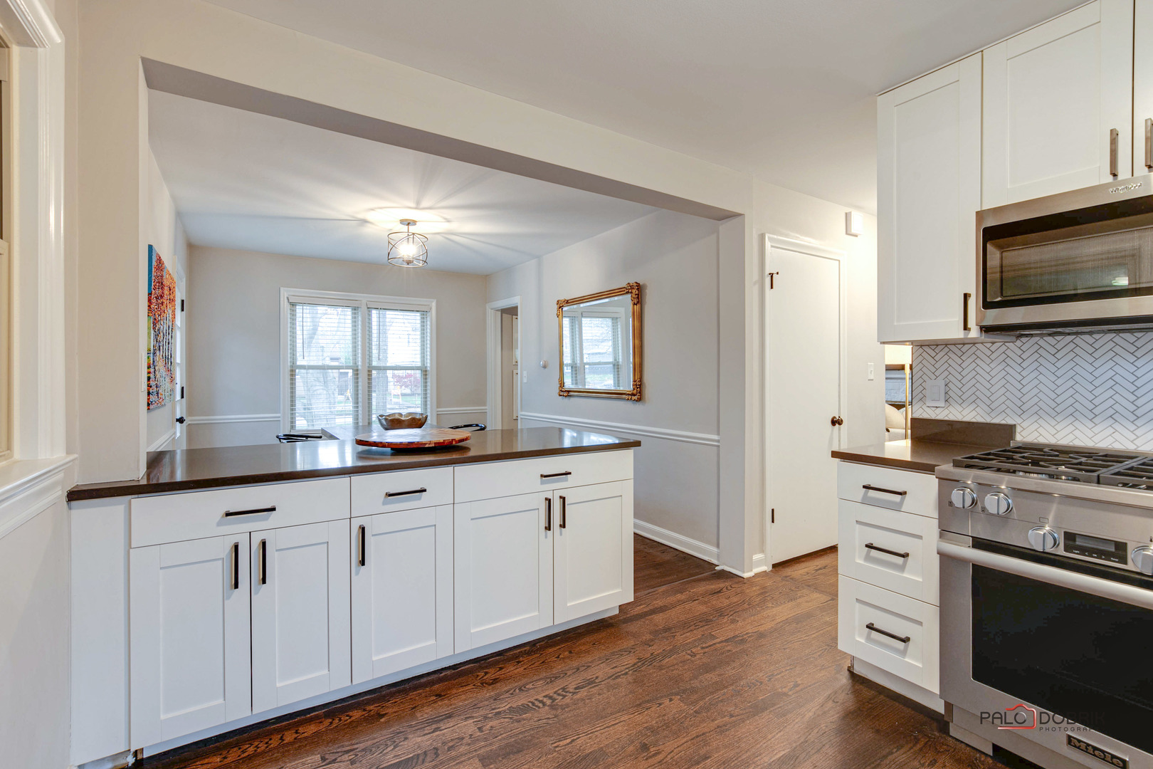 706 Deerpath Drive Deerfield, IL 60015 - Photo 10 of 36 a kitchen with white cabinets and stainless steel appliances