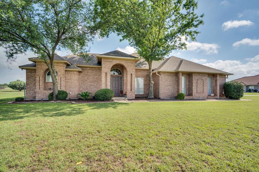 431 Mc Alpin Road Midlothian, TX 76065 - Photo 4 of 18 Brick exterior with a prominent arched entry, mature trees, manicured lawn, and planted landscape beds