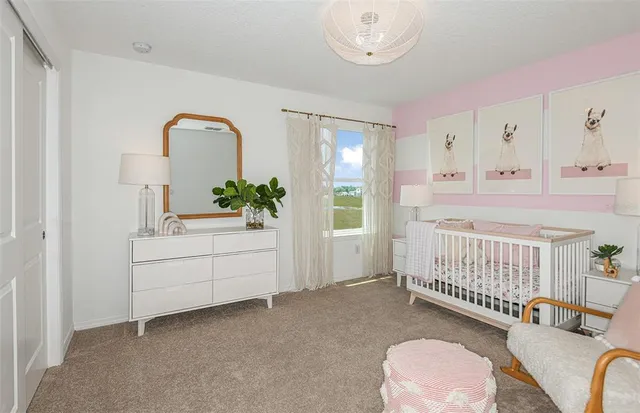 a bedroom with furniture and a large window