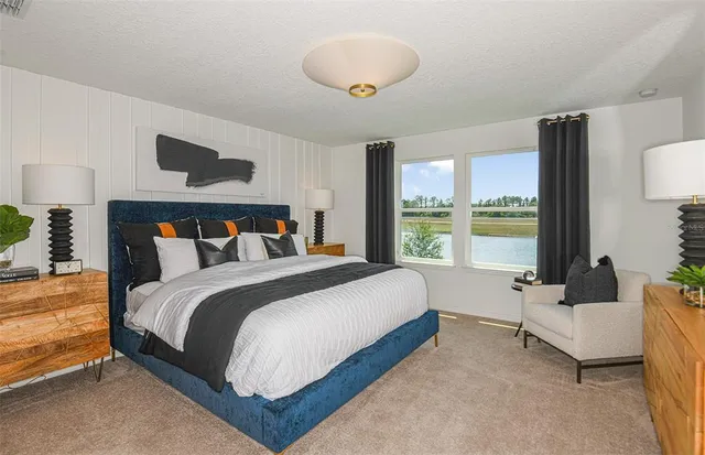 a spacious bedroom with a bed and a large window