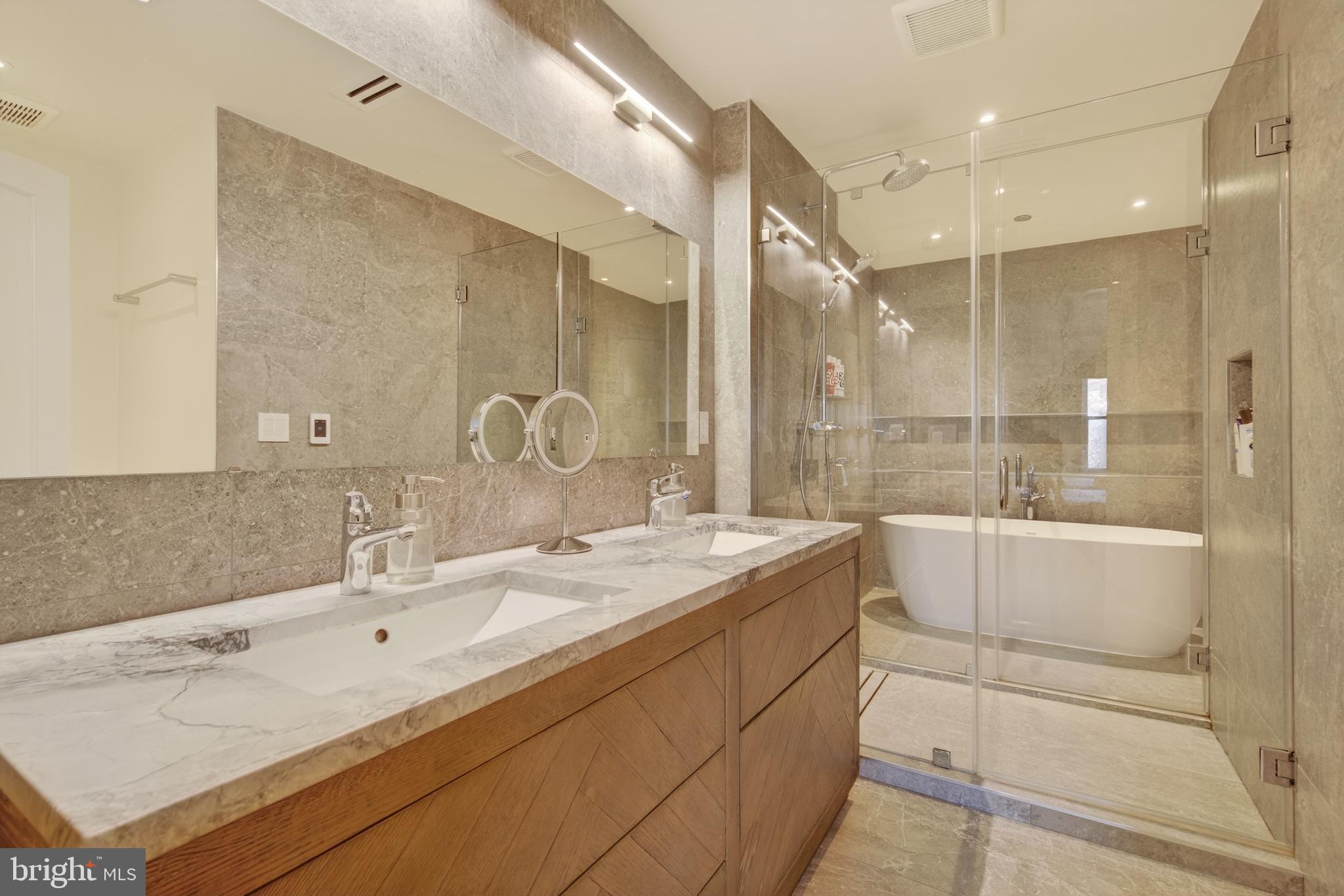 1215 28th Street Northwest, Unit L4 Washington, DC 20007 - Photo 31 of 48 a bathroom with a double vanity sink mirror and shower