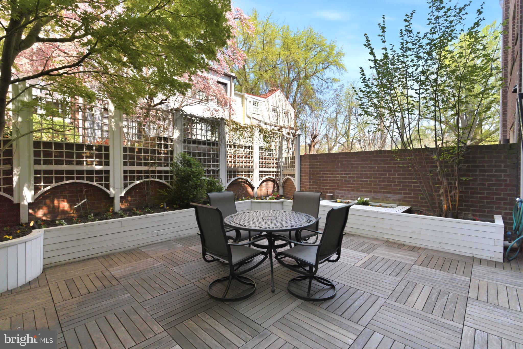 1215 28th Street Northwest, Unit L4 Washington, DC 20007 - Photo 6 of 48 a view of a roof deck with table and chairs and potted plants