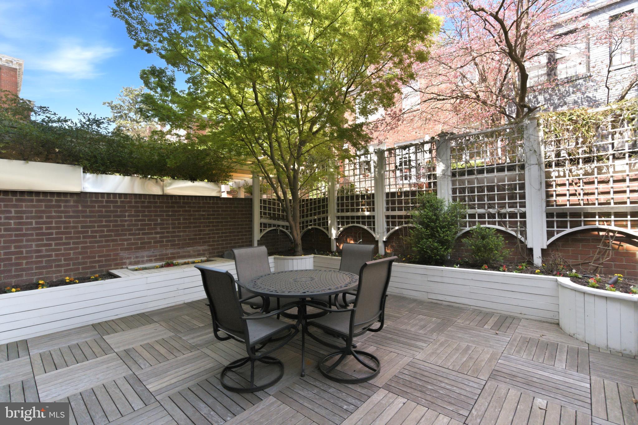 1215 28th Street Northwest, Unit L4 Washington, DC 20007 - Photo 7 of 48 a view of a patio with table and chairs with wooden floor and fence