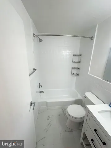 a bathroom with a toilet a sink and shower