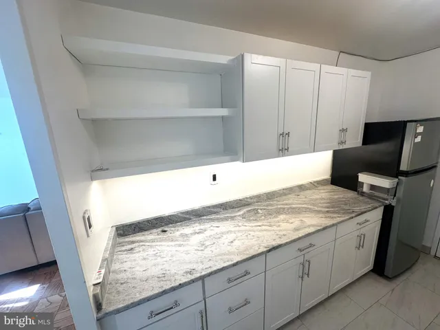 a view of kitchen with furniture and wooden floor