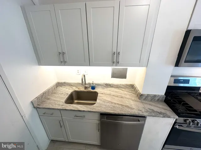 a kitchen with a sink and cabinets