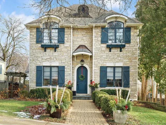 a front view of a house with garden and porch