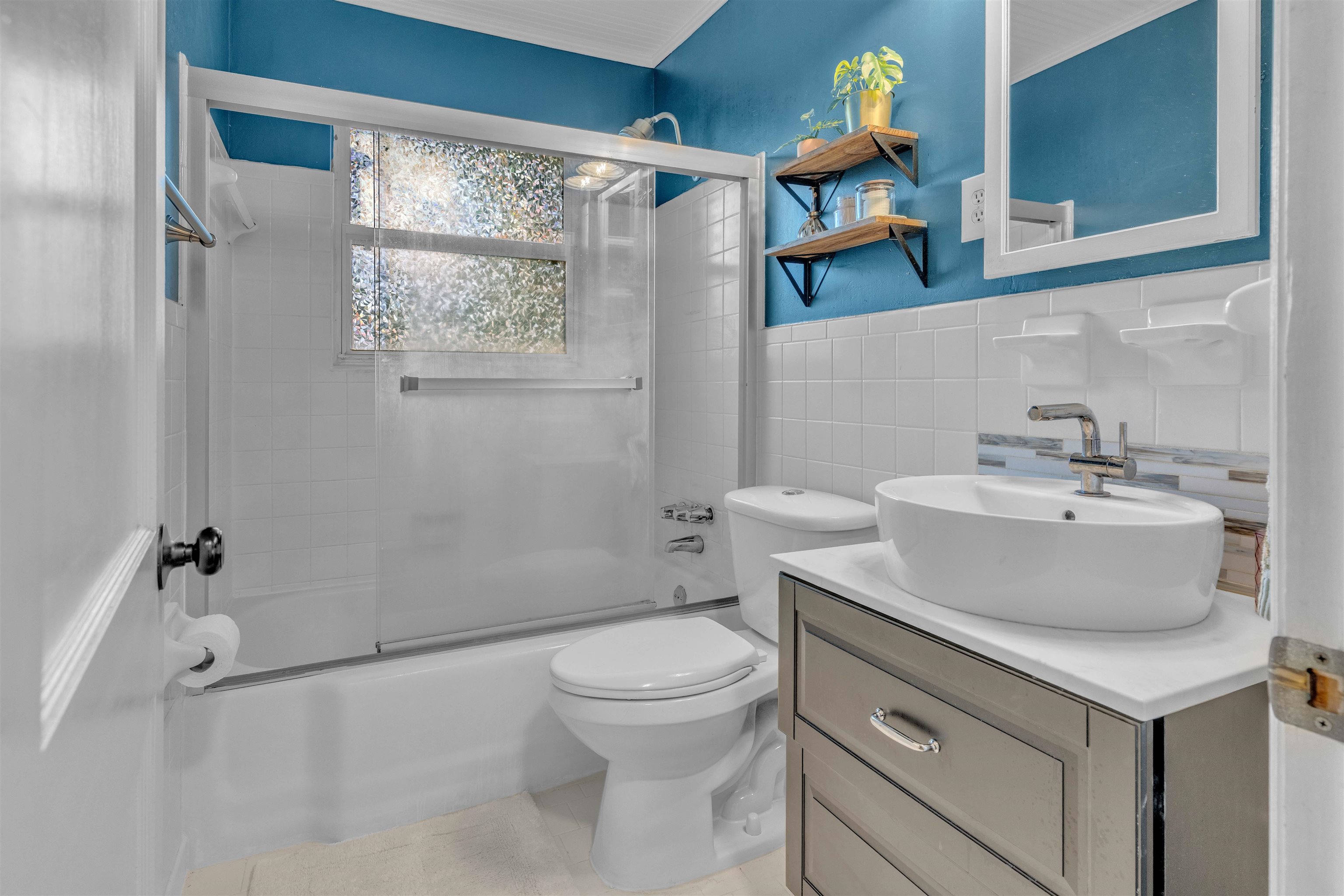 4564 Verne Road Memphis, TN 38117 - Photo 13 of 25 Bathroom featuring a white subway tile surround, vessel sink, and a gray vanity with a white countertop