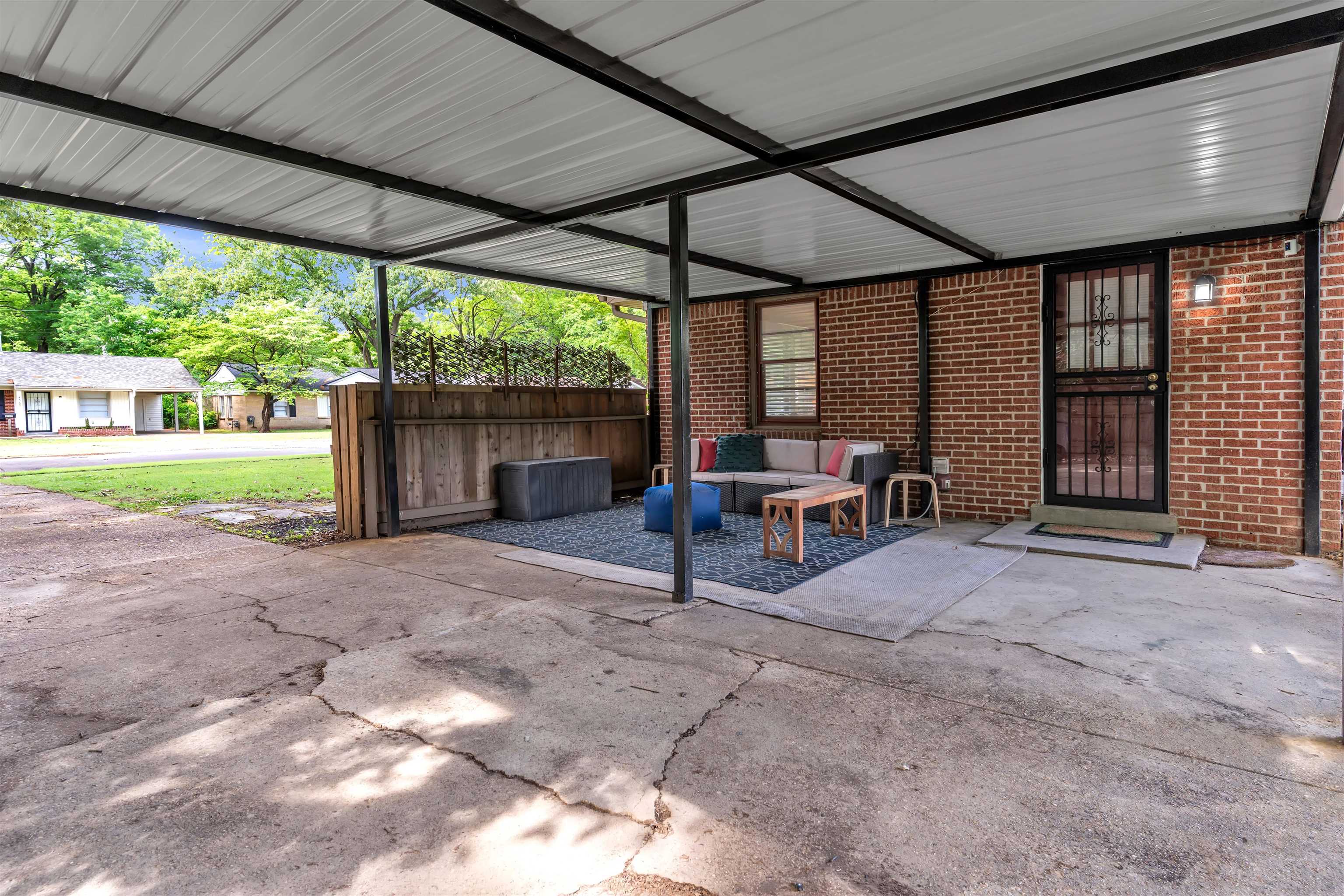 4564 Verne Road Memphis, TN 38117 - Photo 17 of 25 Covered patio area featuring brick exterior walls and a security screen door