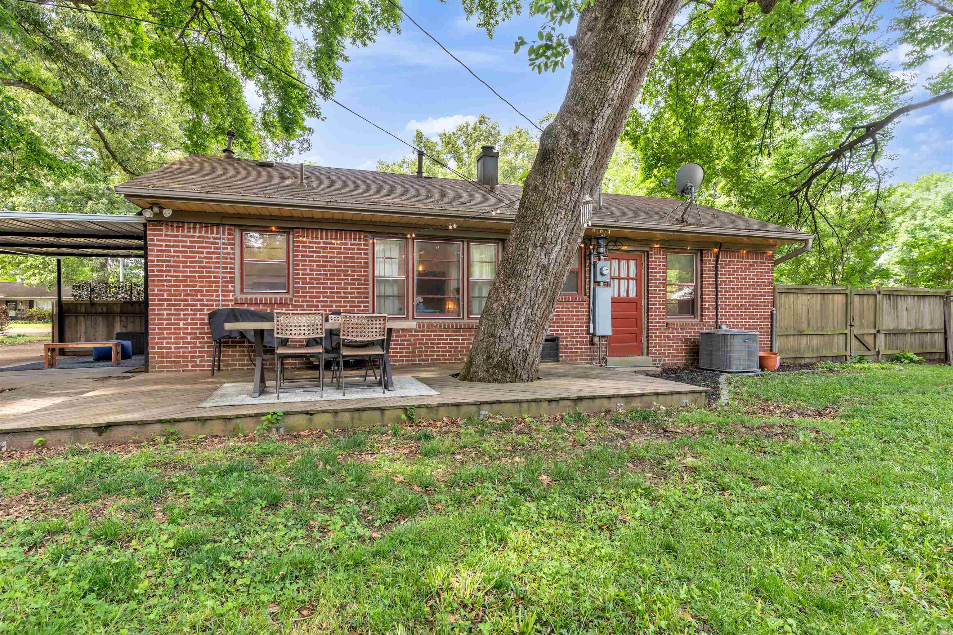 4564 Verne Road Memphis, TN 38117 - Photo 19 of 25 Rear brick exterior featuring a covered patio, additional concrete patio, fenced backyard, and mature trees