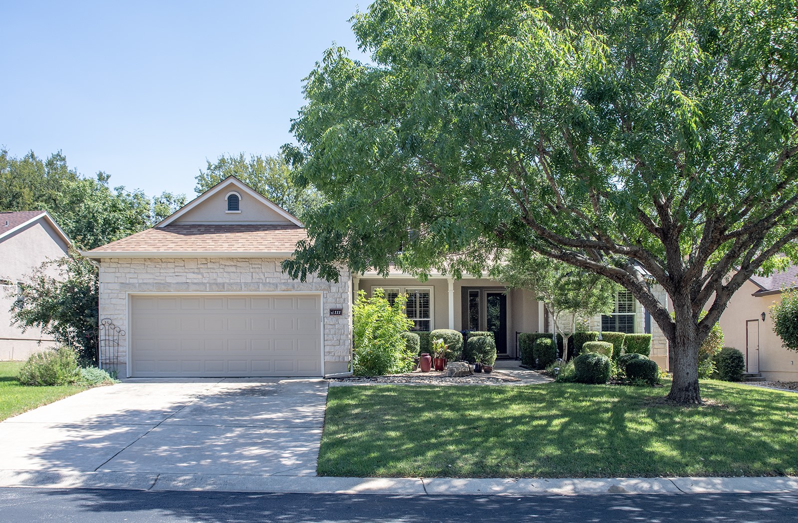 a front view of a house with a yard and garage