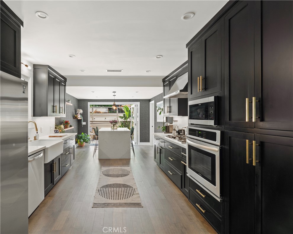 2425 Arthur Street Los Angeles, CA 90065 - Photo 8 of 29 a kitchen with stainless steel appliances a stove sink and microwave