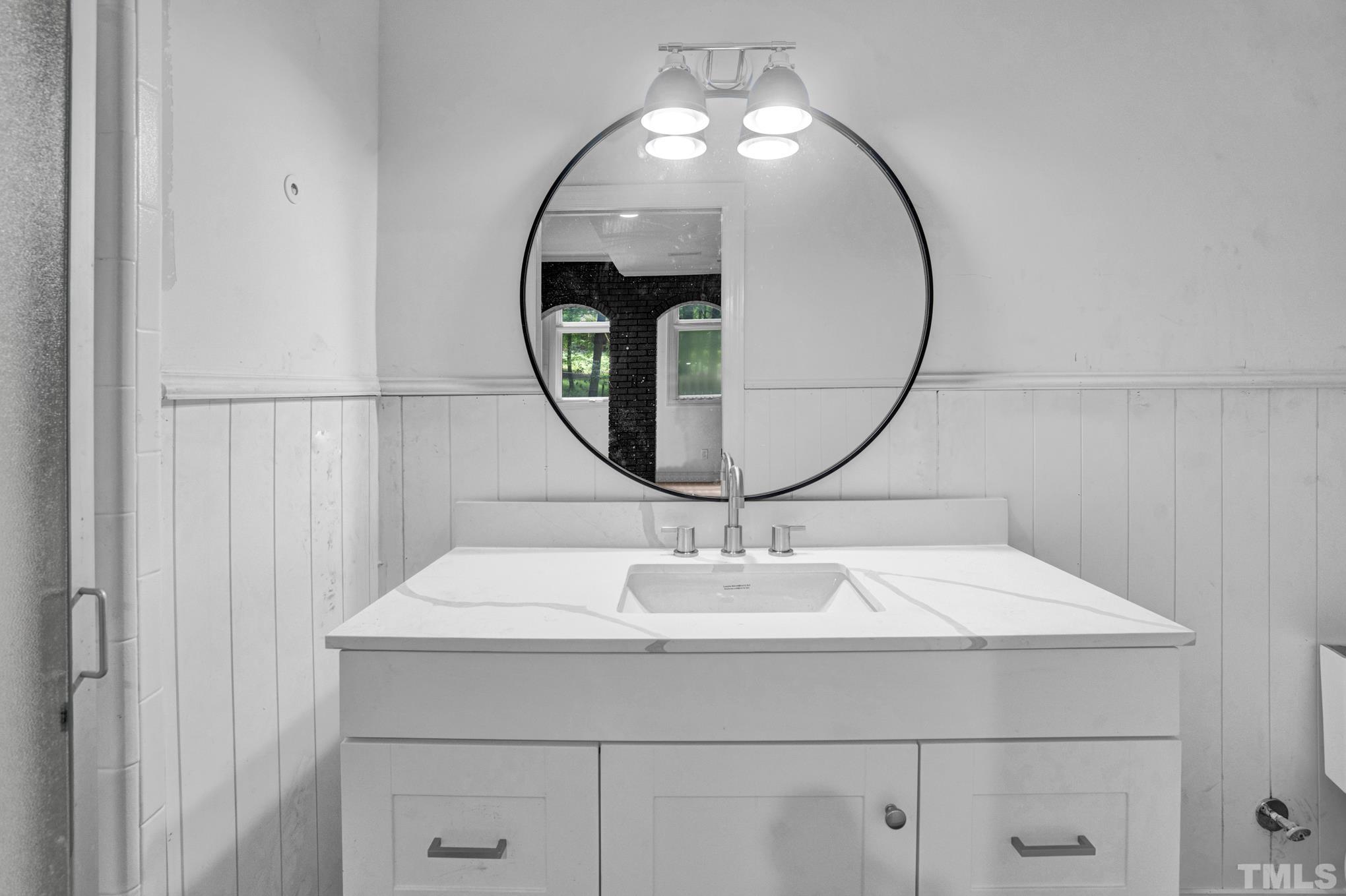 12600 Old Creedmoor Road Raleigh, NC 27613 - Photo 12 of 24 a bathroom with a sink and a mirror