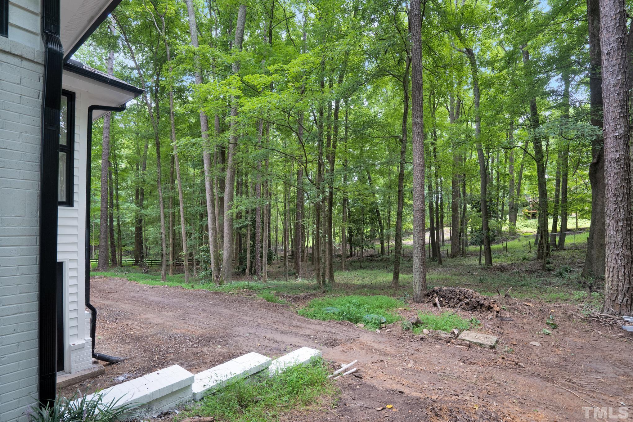 12600 Old Creedmoor Road Raleigh, NC 27613 - Photo 23 of 24 a backyard of a house with outdoor seating and trees