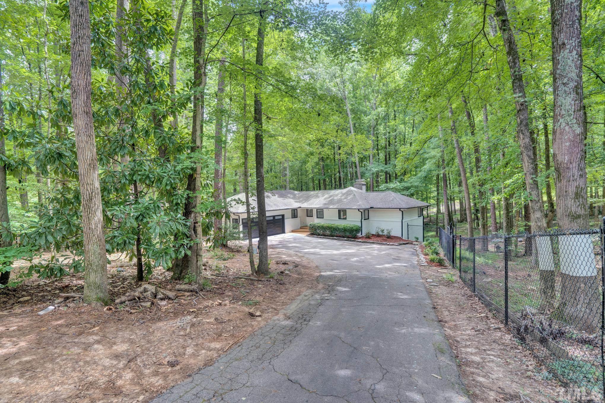 12600 Old Creedmoor Road Raleigh, NC 27613 - Photo 24 of 24 a view of a patio with plants and large trees
