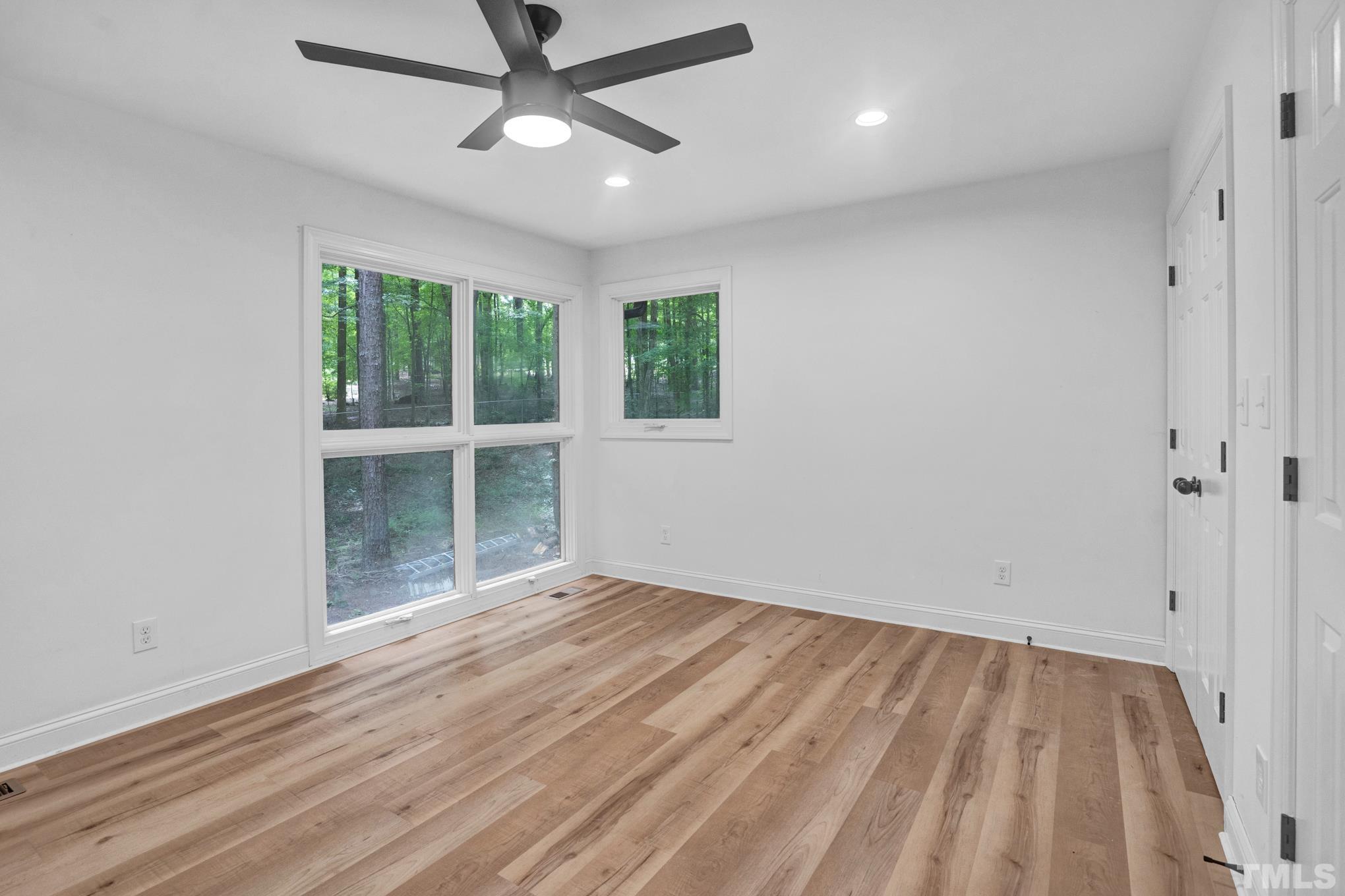 12600 Old Creedmoor Road Raleigh, NC 27613 - Photo 4 of 24 wooden floor in an empty room with a window