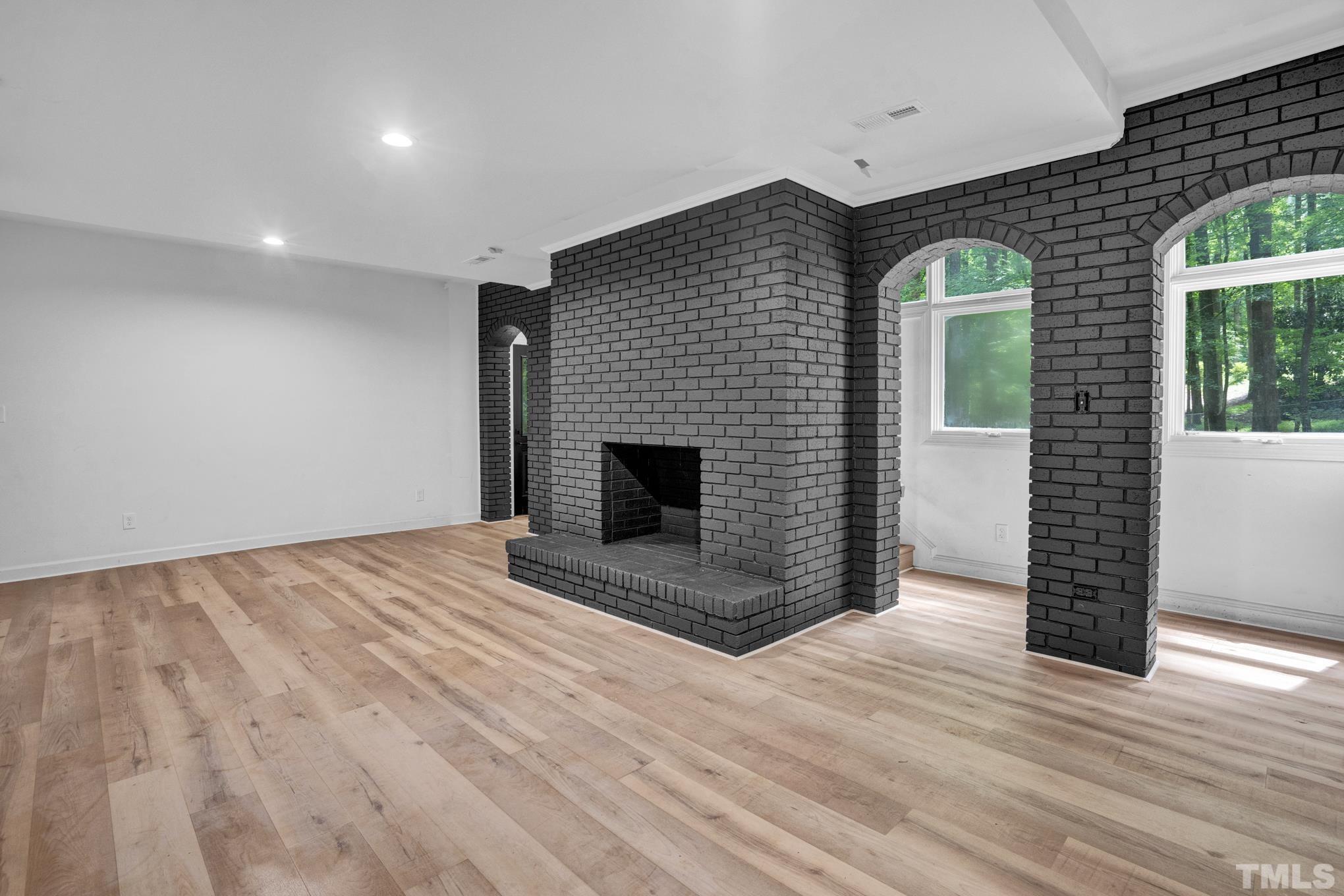 12600 Old Creedmoor Road Raleigh, NC 27613 - Photo 9 of 24 a view of empty room with wooden floor and fireplace