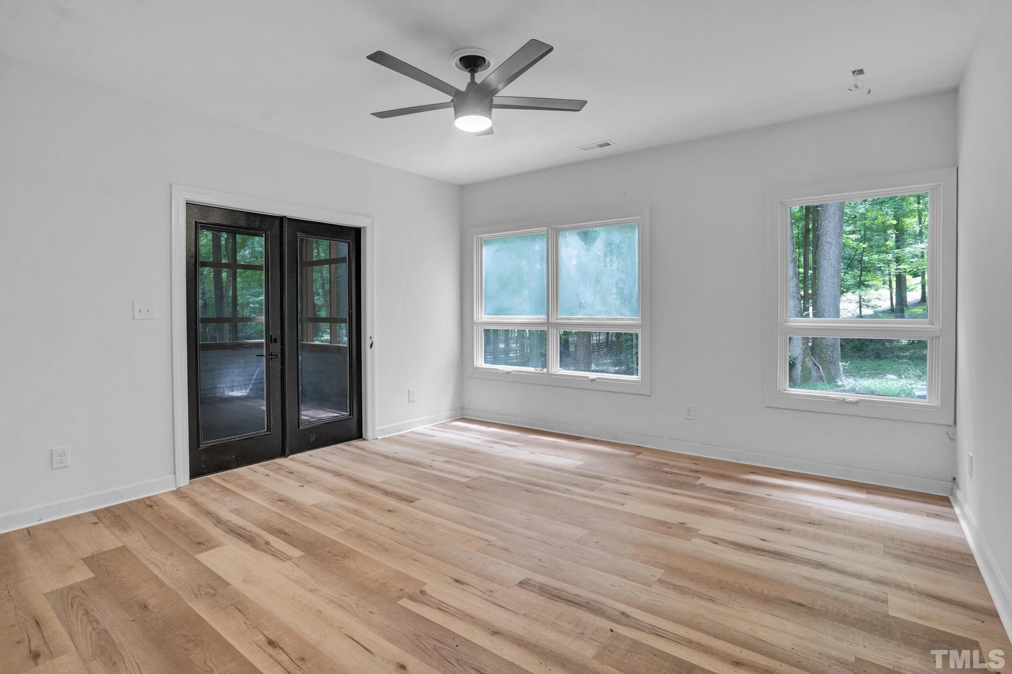 12600 Old Creedmoor Road Raleigh, NC 27613 - Photo 10 of 24 a view of an empty room with a window and wooden floor