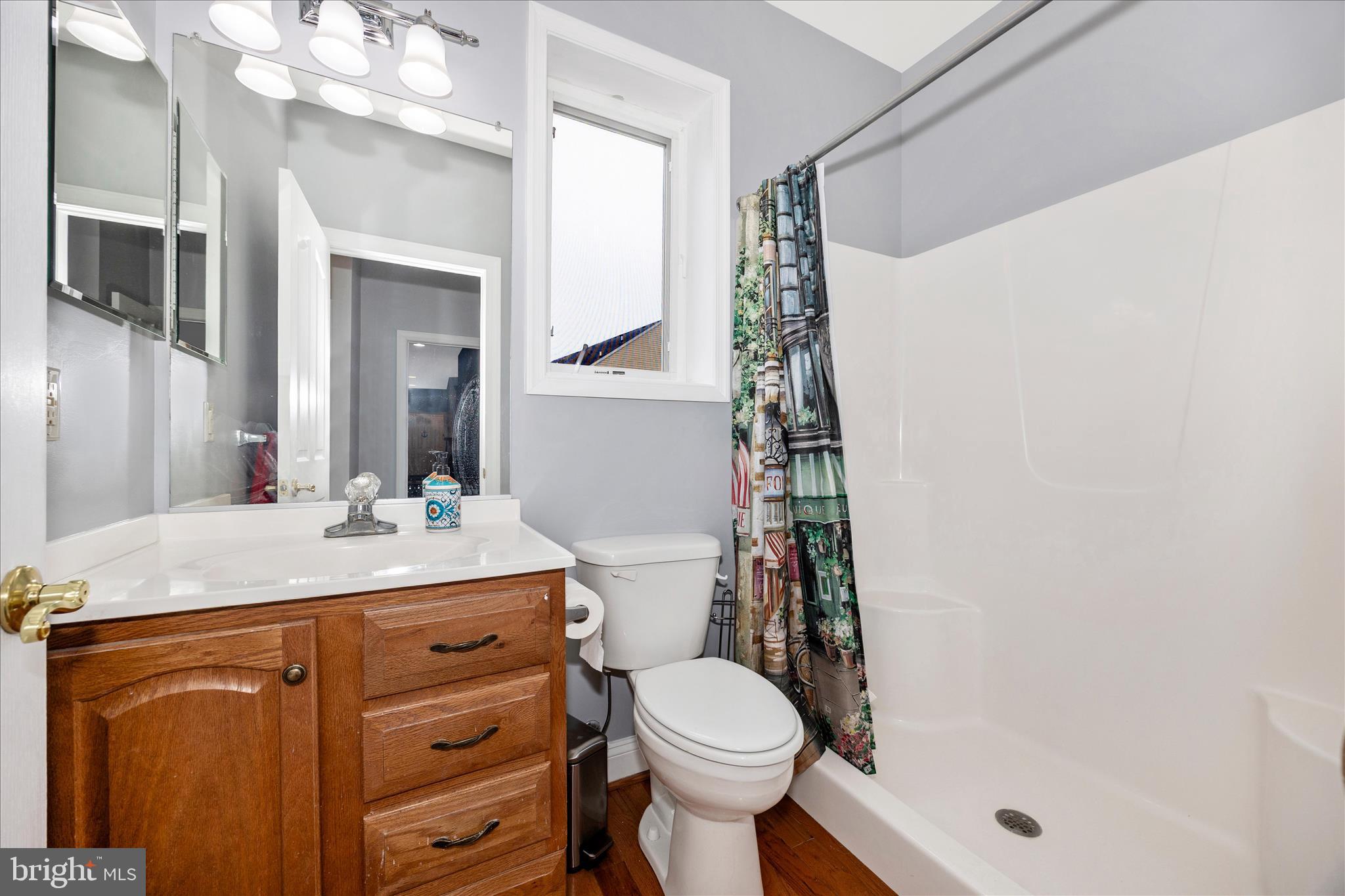 9855 McKinstry Mill Road New Windsor, MD 21776 - Photo 26 of 76 a bathroom with a granite countertop sink toilet mirror and shower