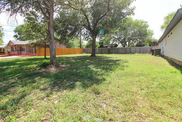 a view of yard with tree and a oven