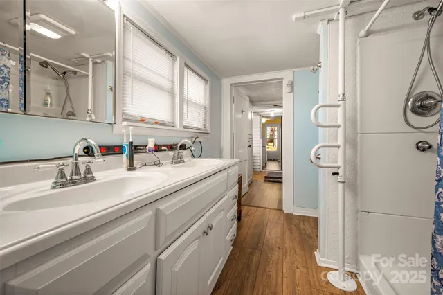 a spacious bathroom with a sink a mirror and a shower