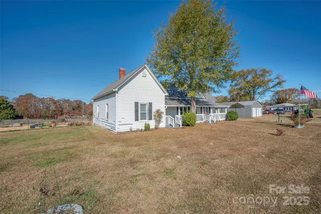 a view of a house with a yard and garage
