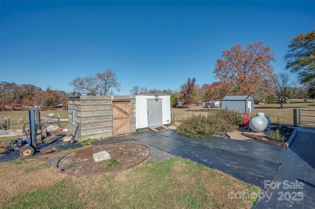 a view of a house with a yard and sitting area