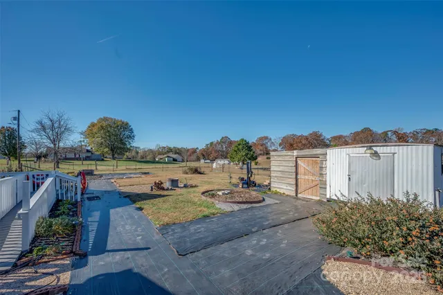 a view of a house with a yard and sitting area