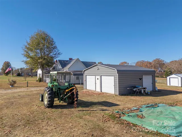 a view of a house with a yard and sitting area