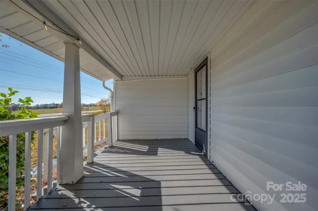 a view of a balcony with wooden floor