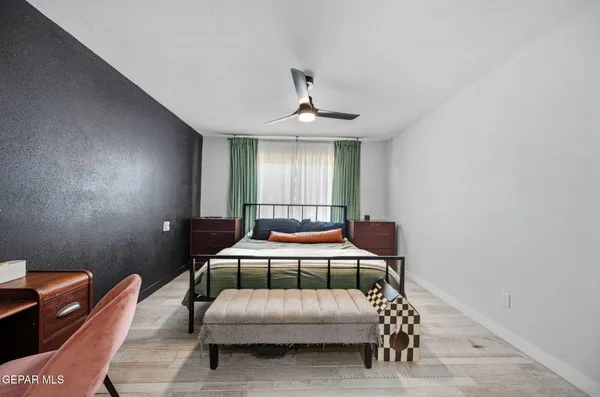 a bedroom with a bed and a chandelier